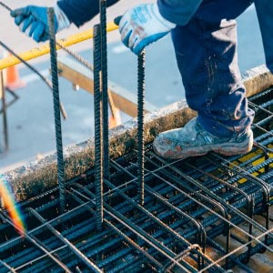 construction worker using safety rules is working on a reinforced concrete slab preparing rebar